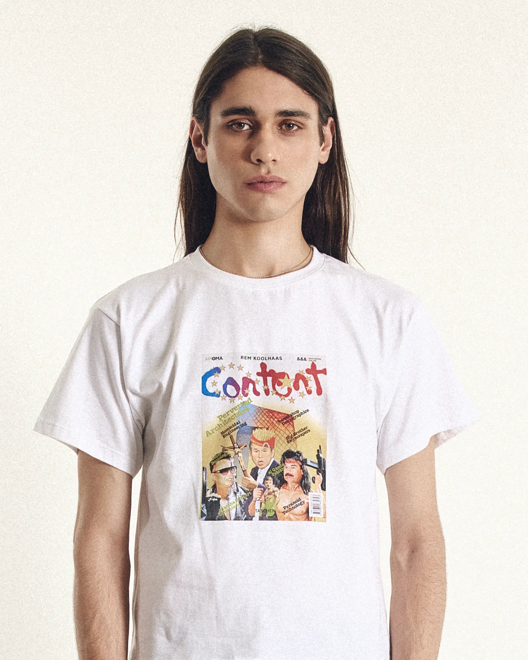 Person wearing a white t-shirt with a graphic design and text on a plain background