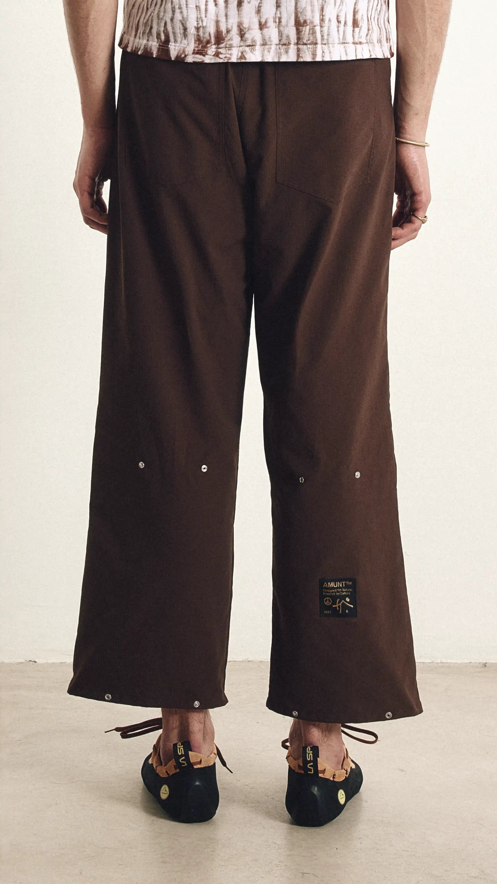 Brown wide-leg pants worn by a person on a plain background