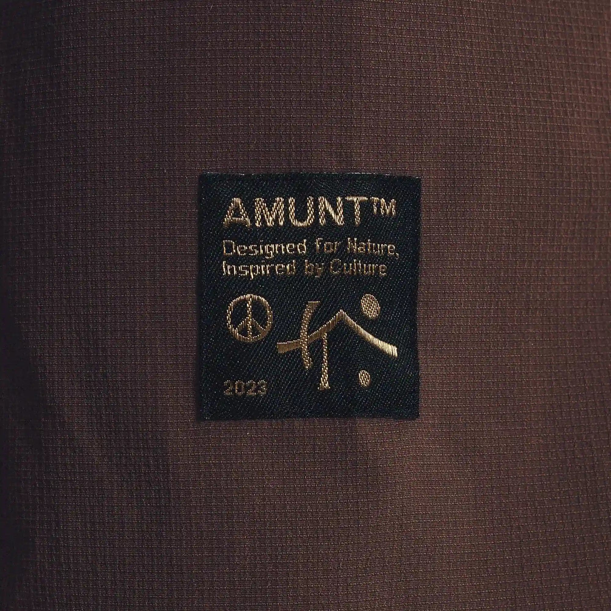 Close-up of a label with 'AMUNT' branding on a brown fabric background