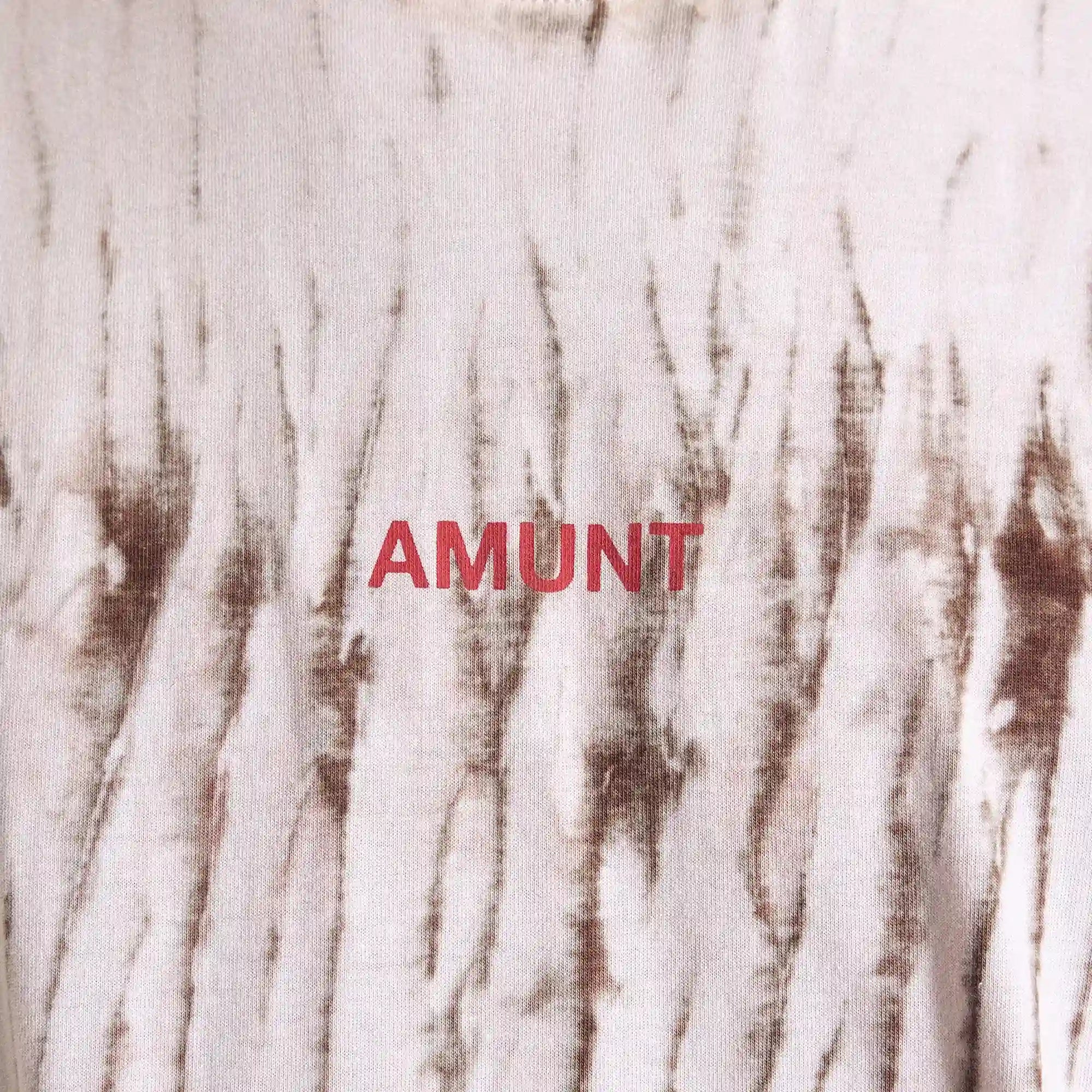 Textured fabric background with 'AMUNT' branding