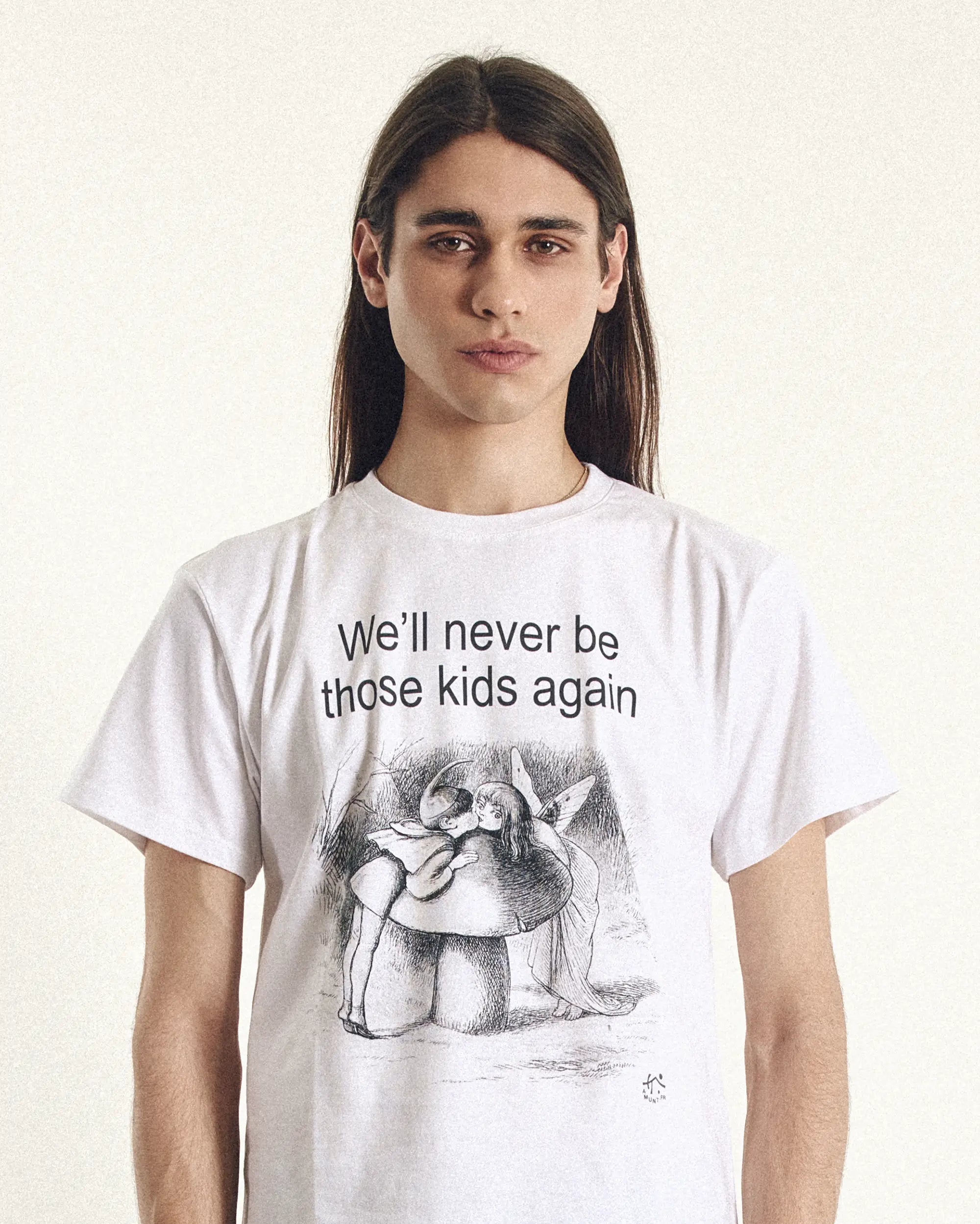 Person wearing a white t-shirt with a graphic design and text on a plain background
