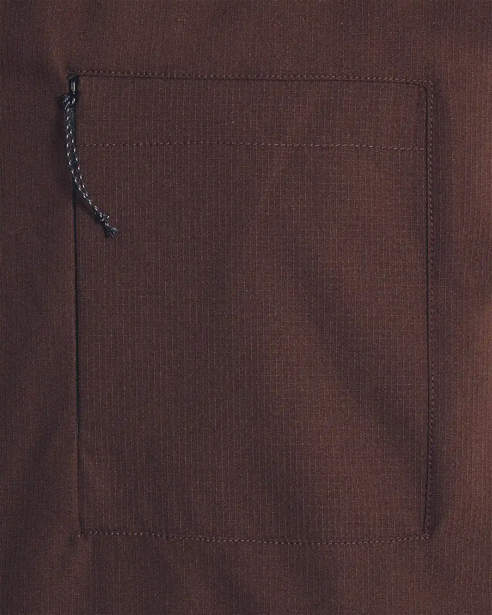 Close-up of a brown fabric pocket with stitching detail