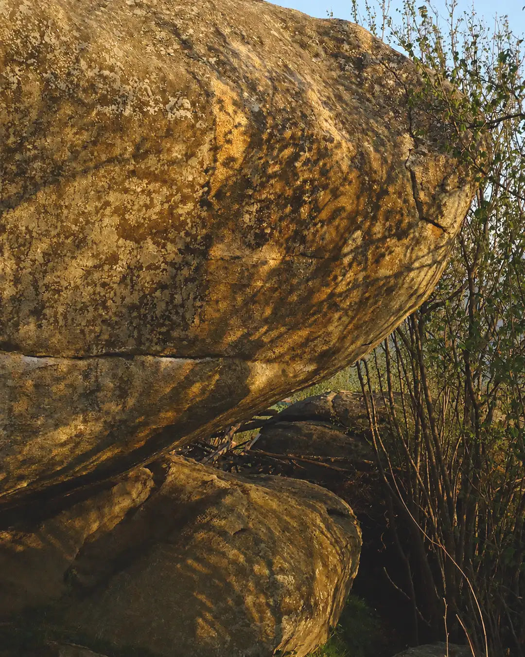 Large rock formation with a natural landscape background